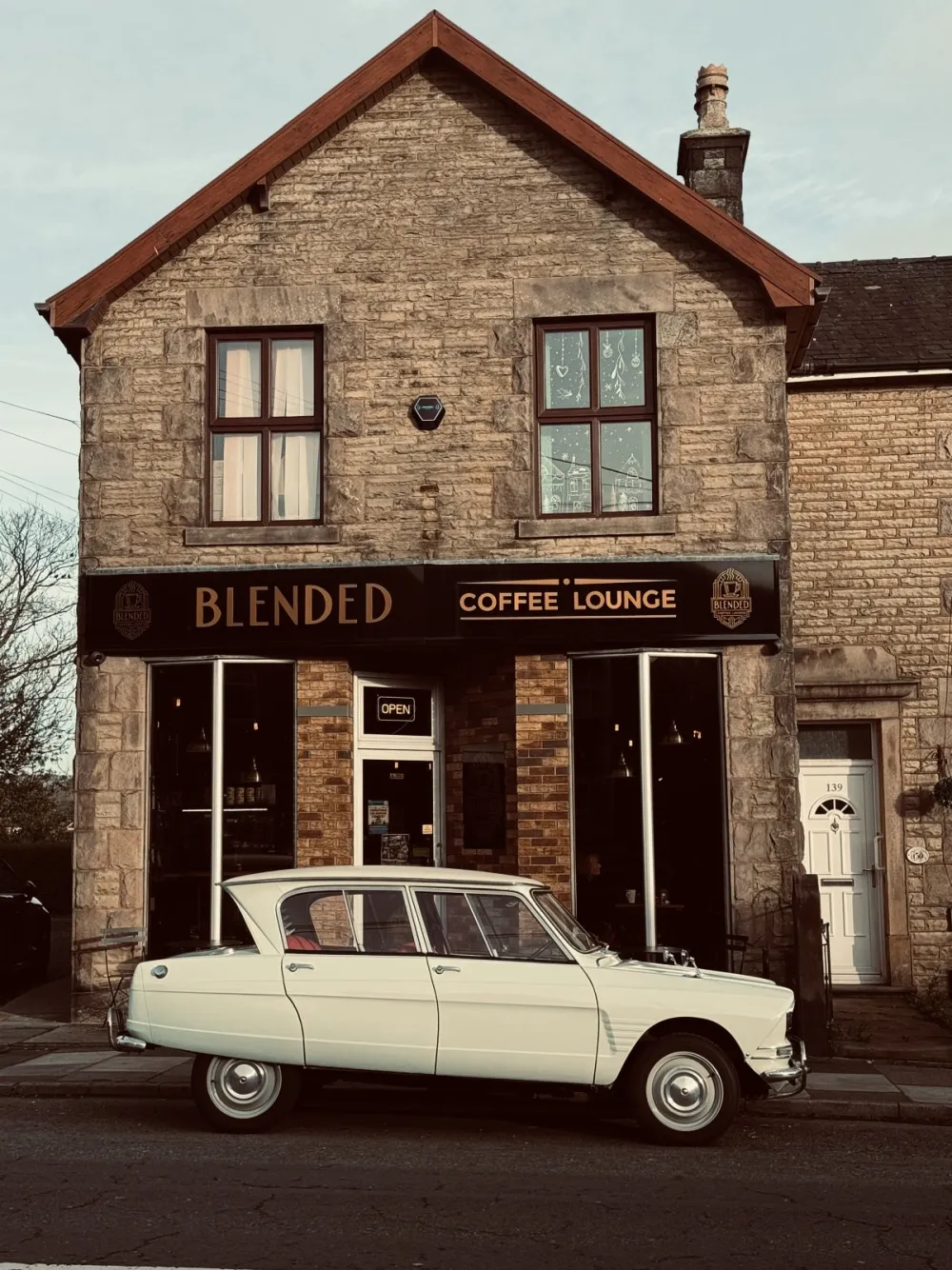 Blended Coffee Lounge storefront by day, a vintage cream Citroën parked outside