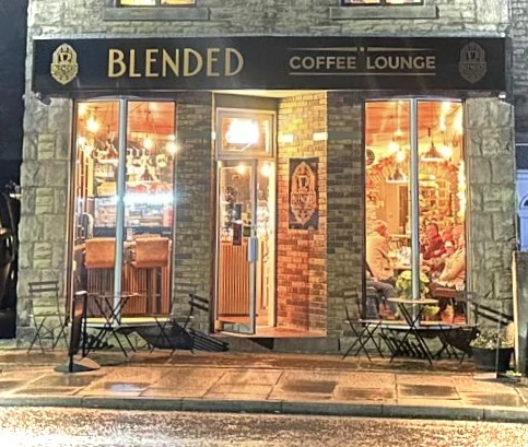 Evening tables outside Blended Coffee Lounge, warmly lit